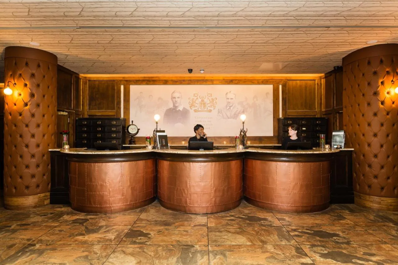 a bar with two people sitting at a counter at The Shankly Hotel in Liverpool